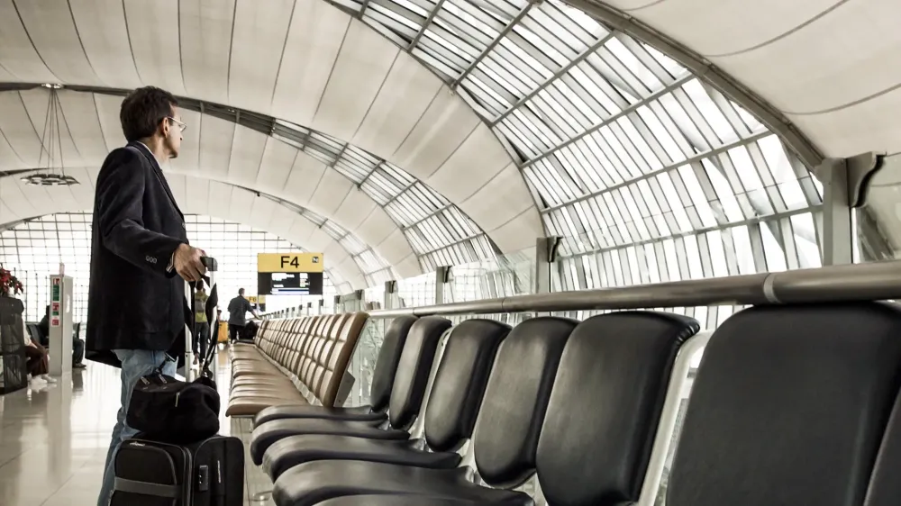 business man with luggage airport seating area